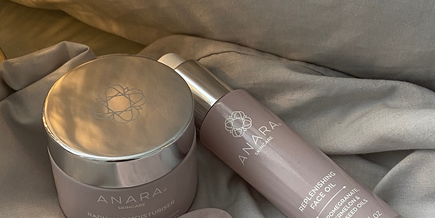 The Anara Skincare Range on a bed with cosy lighting