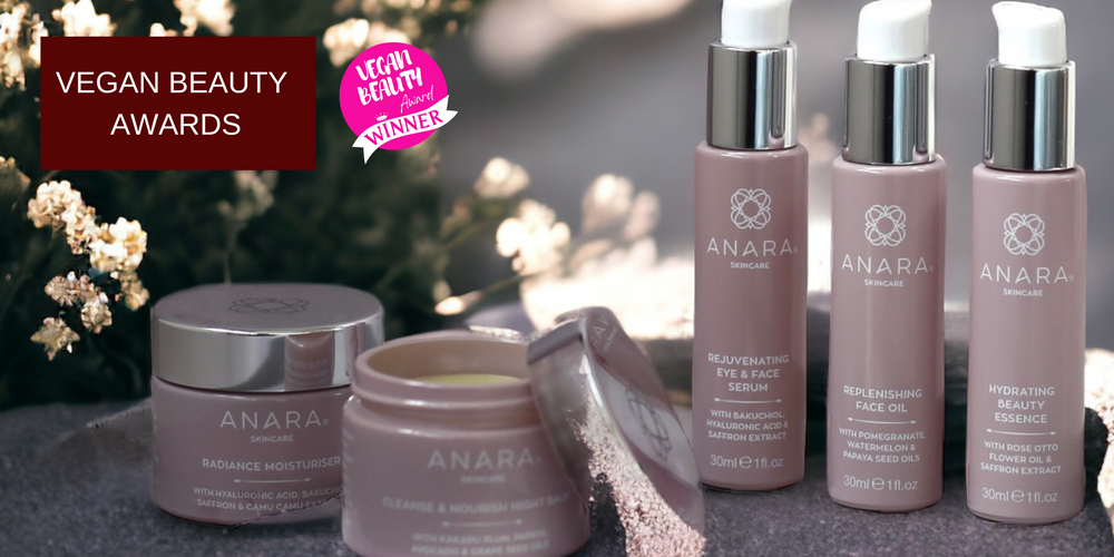 The Anara Skincare range outside surrounded by sunlight and white flowers with the Vegan Beauty Award winner logo.