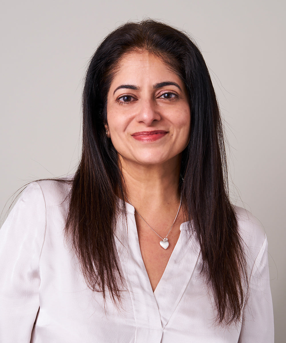 Portrait of Arati Nar, founder of Anara Skincare, looking directly at camera
