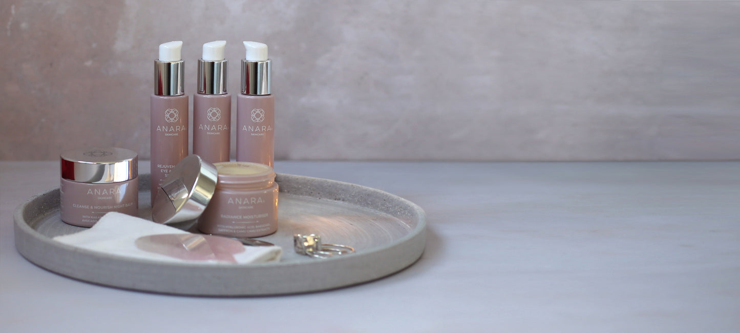 Anara Skincare product range in a lifetyle setting featuring a tray, face cloth and jewellery