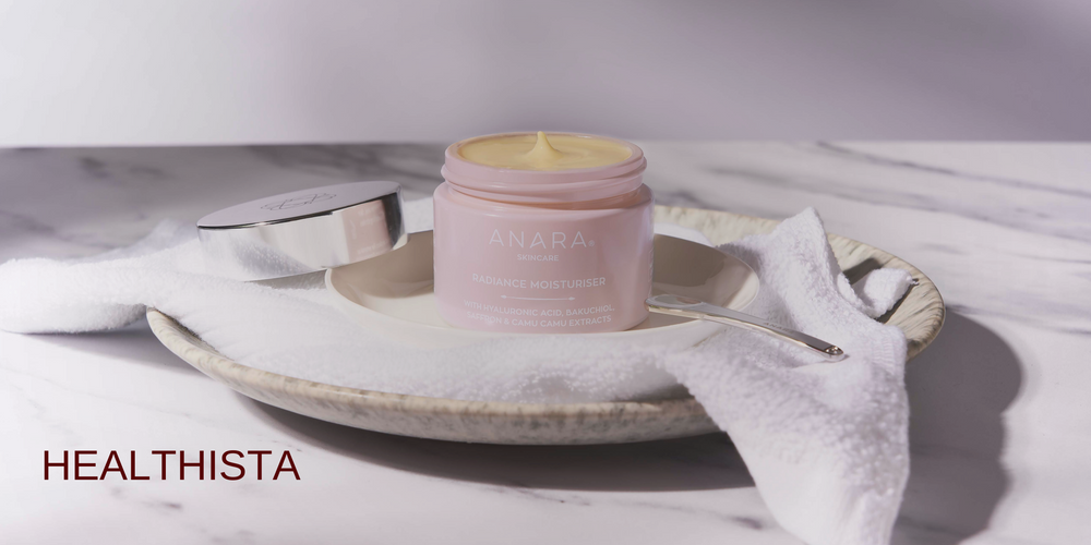 Anara Radiance Moisturiser on a white towel on a plate with lid off